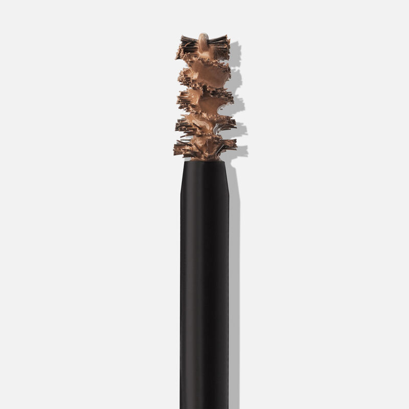 Extreme close up of applicator of Mary Kay Volumizing Brow Tint in shade Brunette